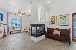 a living room with a fireplace and a couch at Sea Manor in New Smyrna Beach