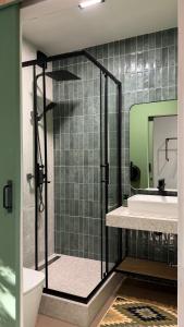 a bathroom with a shower and a sink and a mirror at Molfar green 