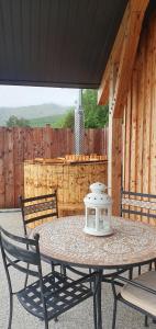 a table with a light on it on a patio at Carrick Chalets in Cairndow