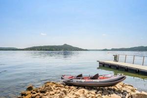 two boats sitting on the shore of a lake at Large lakeside villa in Lesa