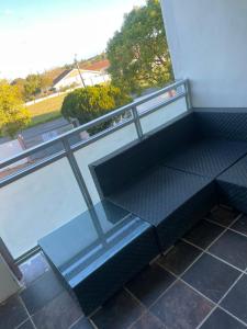 a balcony with a bench on a building at Executive B & B in Beacon Bay