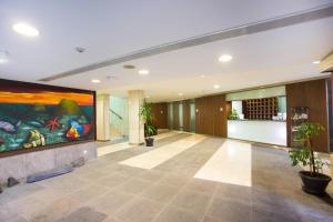 an empty lobby with a large painting on the wall at Antillia Hotel in Ponta Delgada