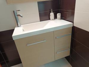 a bathroom with a sink and a mirror at KTHMA "Ν" Πέτρινη Μεζονέτα in Ververáton +89 photos