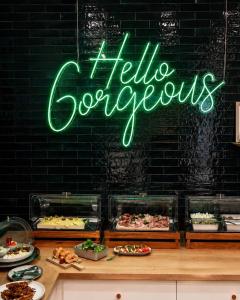 a neon sign that says hellorocopus in front of a buffet at Boutique-Hotel "Stilvoll" in Andernach