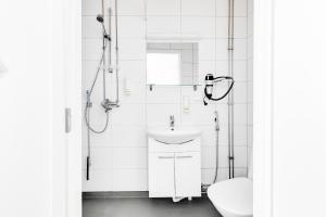 a bathroom with a toilet and a sink at LODGE Aparthotel Raahe in Raahe +15 photos