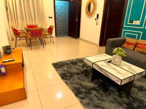 a living room with a couch and a table at Immobilier du siecle in Abidjan