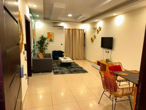 a living room with a couch and a tv at Immobilier du siecle in Abidjan