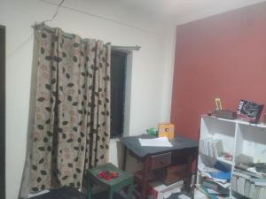 a room with a curtain and a desk and a window at Gupta House in Katmandu International
