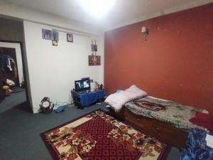 a room with a bed and a tv in it at Gupta House in Katmandu International