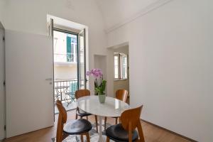 a dining room with a white table and chairs at Design Apartment in Monopoli