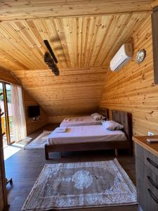 a bedroom with a bed in a wooden cabin at Naimi in Pukë