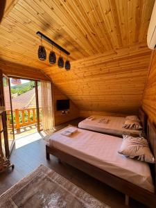 a bedroom with a bed in a wooden room at Naimi in Pukë