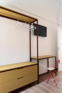 a bedroom with a bed and a desk and a chair at Design Apartment in Monopoli