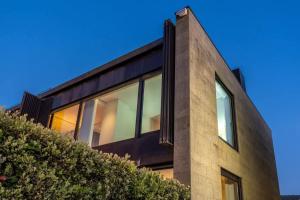 a house with glass windows on the side of it at Moledo Front Beach by Portugal Active in Viana do Castelo +80 photos