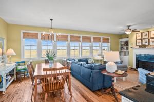 a living room with a blue couch and a table at Harbor Island 71 Harbor Drive in Nautical Watch Villas