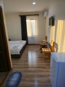 a hotel room with two beds and a table at NUR TOON in Areni