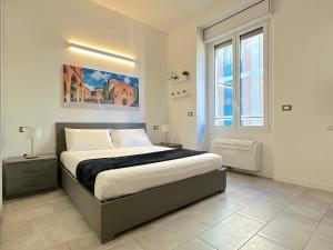 a bedroom with a bed and a large window at Demetra Apartment in Bologna