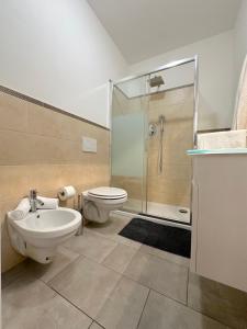 a bathroom with a toilet and a sink and a shower at Demetra Apartment in Bologna