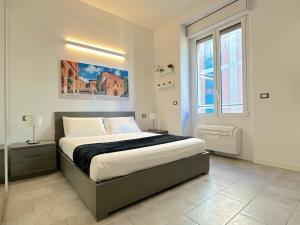 a bedroom with a bed and a large window at Demetra Apartment in Bologna