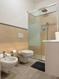 a bathroom with a toilet sink and a shower at Demetra Apartment in Bologna +18 photos