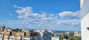 a view of a city with buildings and clouds at Diamond Hall Черкассы in Cherkasy
