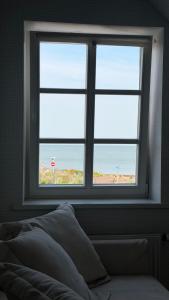 a bedroom window with a view of the beach at Lotmiškio 1 in Neringa +31 photos