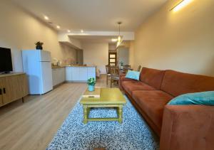 a living room with a couch and a table at Bracka Dom in Pabianice