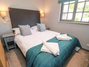 a bedroom with two beds with towels on them at 7 Brunston Avenue in Girvan