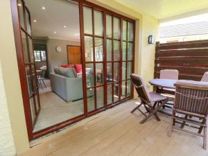a living room with a table and chairs and a couch at 7 Brunston Avenue in Girvan