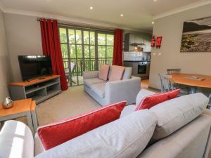 a living room with a couch and a tv at 7 Brunston Avenue in Girvan