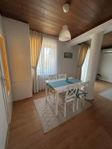 a dining room with a white table and chairs at Apartment 086 in Cetinje