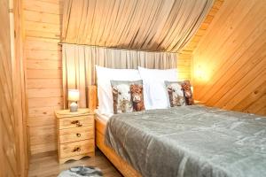 a bedroom with a bed with two dogs on the pillows at Domek u Hanci Pod Gubałówką z Jacuzzi in Ząb +78 photos