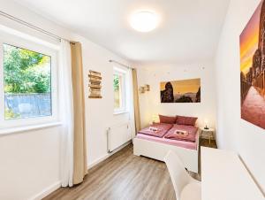 a bedroom with a bed and a window at Urlaubsmagie Ferienwohnung Wiesengrün - direkt am Wanderweg - für 6P - W6 in Sebnitz +15 photos