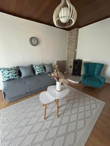 a living room with a blue couch and a table at Apartment 086 in Cetinje