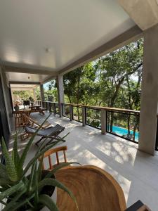 a balcony with chairs and a view of a pool at Shalpabay house - Private Apartments and Rooms in Taquillo
