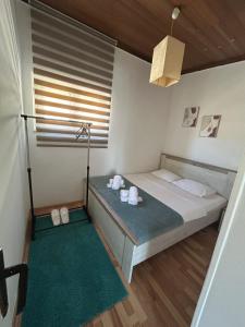 a small bedroom with a bed and a window at Apartment 086 in Cetinje +15 photos