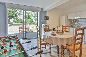 a dining room with a table and a pool table at L'échappé Belle du Bessay in Avrillé