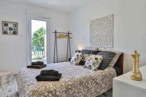 a bedroom with a bed with pillows on it at L'échappé Belle du Bessay in Avrillé