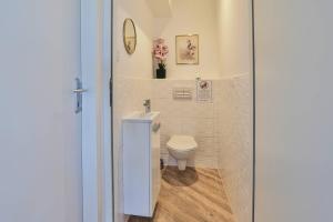 a bathroom with a toilet and a sink at L'échappé Belle du Bessay in Avrillé +22 photos