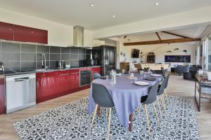 a dining room with a table and chairs in a kitchen at Gite du Bord de mer in Avrillé
