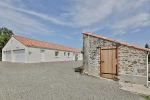 a building with two garages next to each other at Gite du Bord de mer in Avrillé