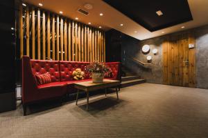 a red couch in a room with a table at H Boutique Peña Parda in La Herradura