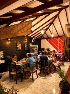 a group of people sitting at tables in a restaurant at White Villa Airport Transit Hotel in Katunayaka