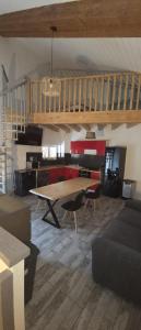 a living room with a large wooden table and chairs at Maison de ville in Roquemaure