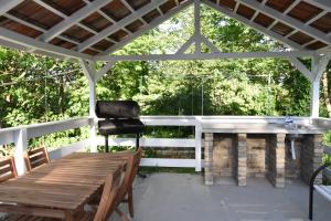 a patio with a grill and a table and chairs at Ana apartmani in Pačir