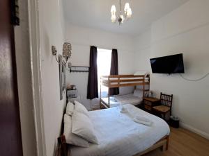 a bedroom with a bed and a tv in it at The West Pier Residence in Brighton & Hove