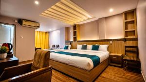 a bedroom with a large bed in a room at Hotel City Center in Bhairāhawā