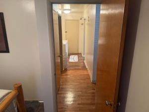 a hallway with a door leading to a bathroom at Dash House in Deadwood