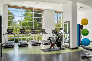 a gym with treadmills ellipticals and exercise bikes at Archer Hotel Seattle/Redmond in Redmond