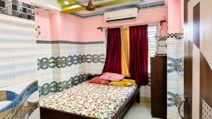 a bedroom with a bed in a room at Hotel Protima guest inn in Digha